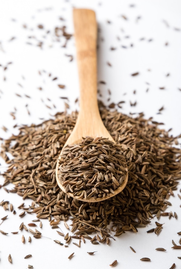 Caraway seeds in a wooden spoon