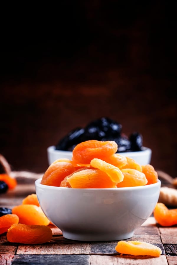 Dried apricots with dried prunes in the background