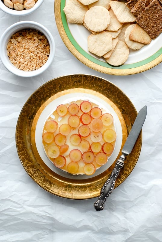 Baked Brie with Pink Champagne Jelly, Red Grapes and Marcona Almonds with knife