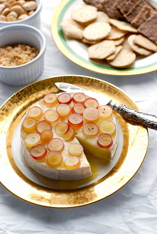 Baked Brie with Pink Champagne Jelly, Red Grapes and Marcona Almonds with slice removed