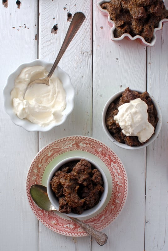 Gingerbread Eggnog Bread Pudding in bowls with whipped cream