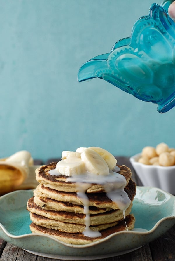 Banana-Macadamia Nut Pancakes with Coconut Syrup stack