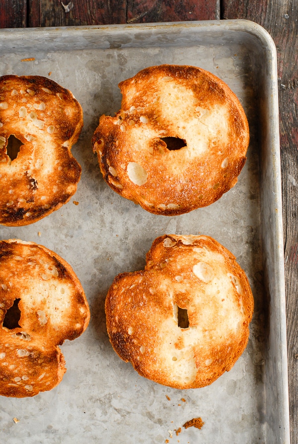 toasted bagel halves on baking sheet