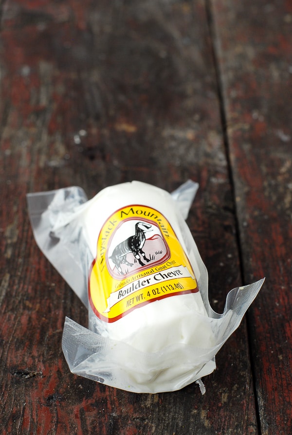 package of goat cheese on wood surface