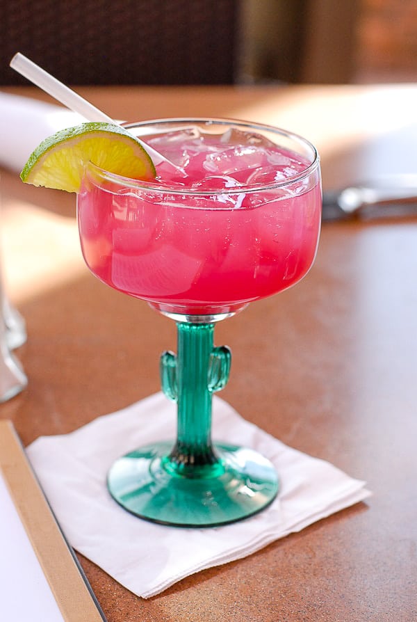 Prickly Pear Margarita in cactus glass with straw
