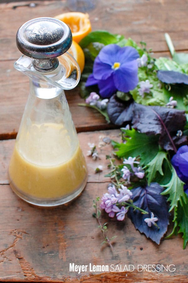 Homemade Meyer Lemon Salad Dressing recipe in an antique cut crystal carafe with fresh spring greens