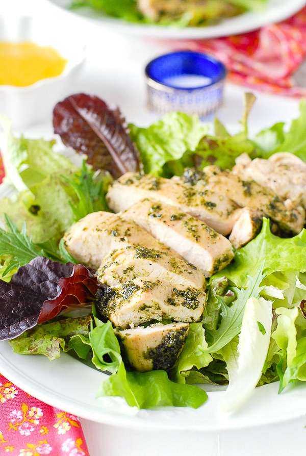 Juicysliced boneless chicken breast topped with tarragon pesto on salad greens with meyer lemon dressing.