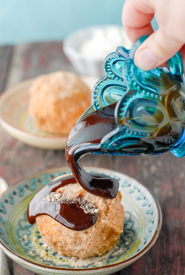 drizzling chocolate syrup onto freshly fried ice cream 