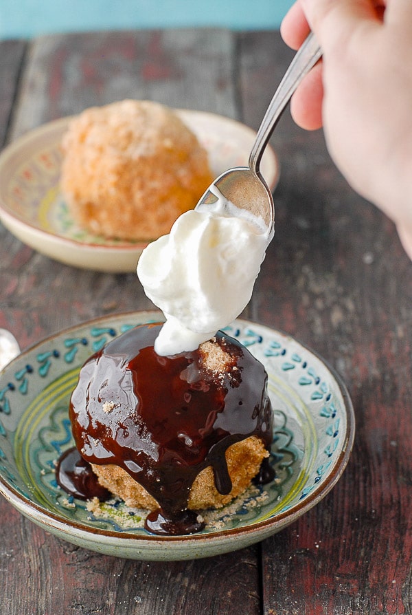 adding whipping cream to churro fried ice cream with chocolate 