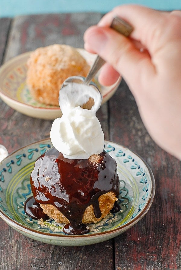 churro fried ice cream with chocolate syrup and dollop of whipping cream