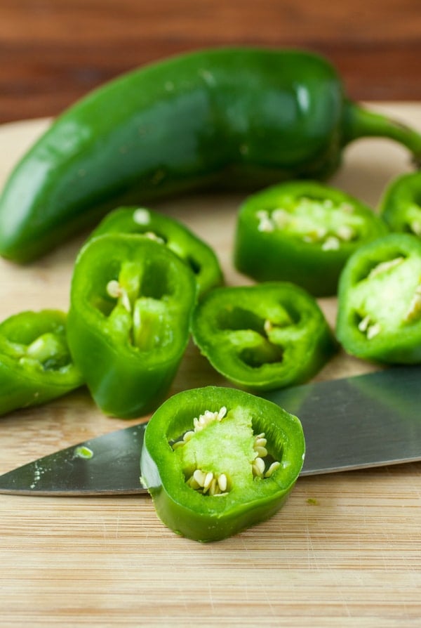 Whole and sliced jalapeno chile peppers