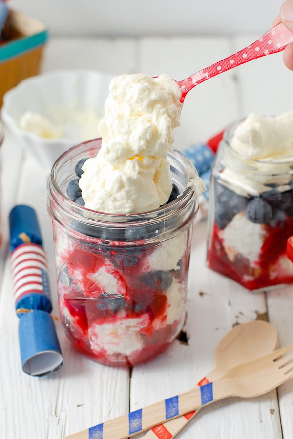 Red White and Blue trifles in Mason jars with whipped cream