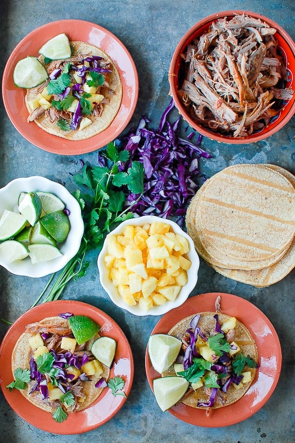 Plates of Tacos Al Pastor and extra ingredients