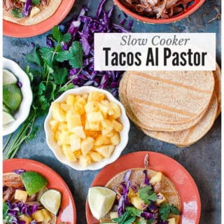 Tacos Al Pastor on small plates with pineapple chunks