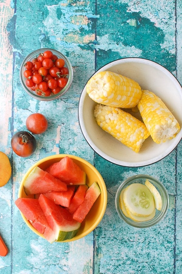 Corn, watermelon, cherry tomatoes, peaches, pork