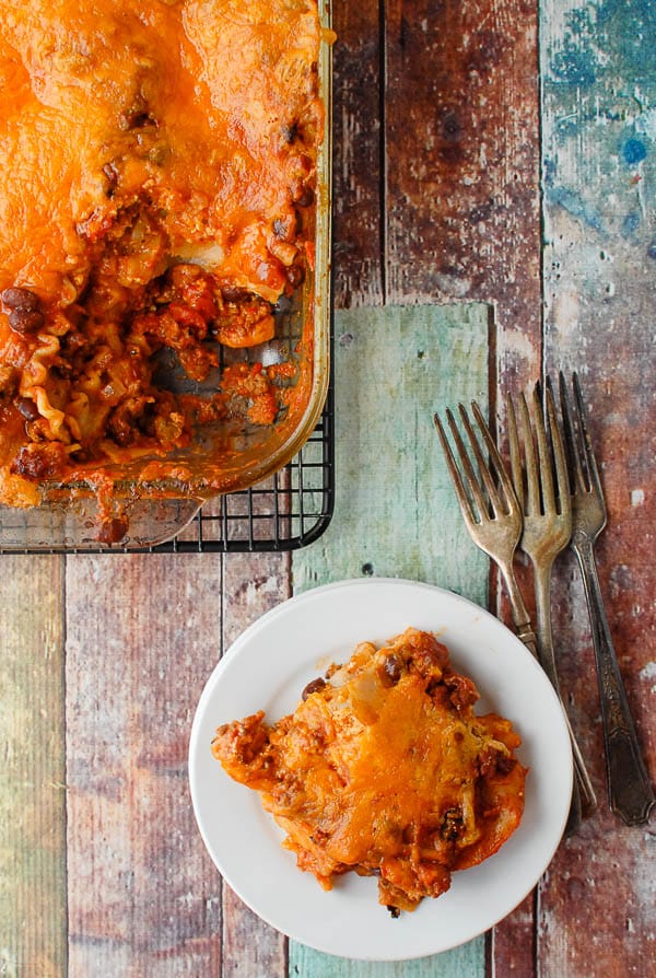 Mexican Lasagna serving on plate with lasagna pan