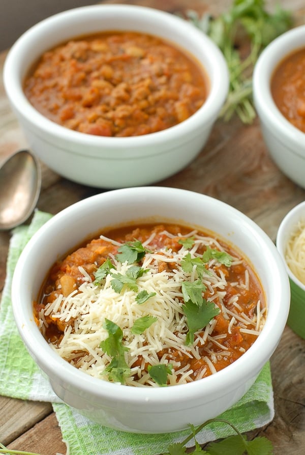 Slow Cooker Pumpkin White Bean Sausage Chili with grated cheese