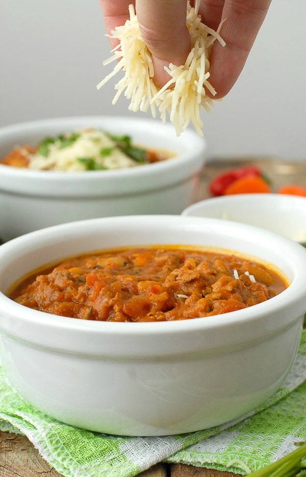 Pumpkin White Bean Chili and grated cheese in white bowl