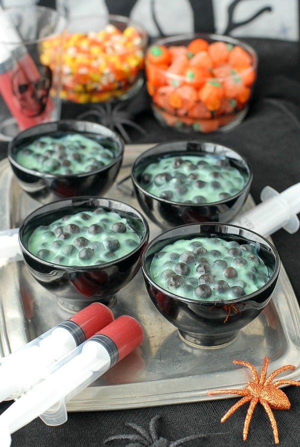 Creepy Spider Egg Pudding in black bowls on tray