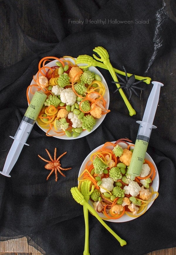 Freaky Healthy Halloween Salad made with spiralized vegetables. 2 syringes hold the salad dressing