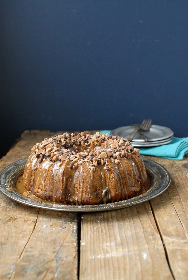 Pumpkin Spice Buttermilk Bundt Cake with Dark Salted Caramel Glaze on vintage crate 