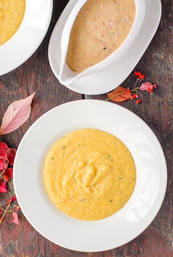 Pumpkin polenta and maple bacon gravy in white bowls