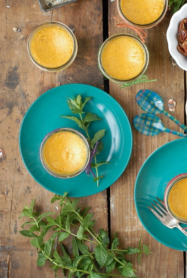 Mini Pumpkin Pie Cheesecakes in Mason Jars with mint sprigs