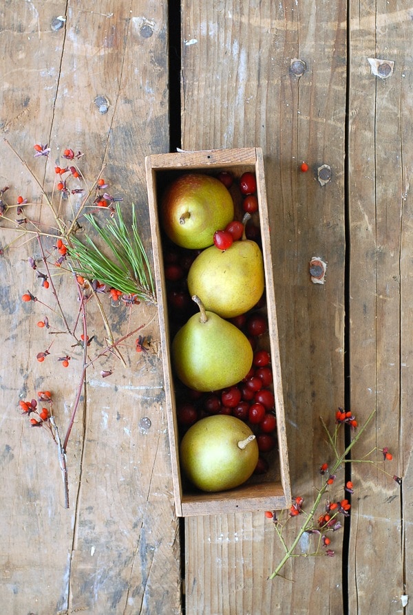 Pears and Cranberries in vintage cheese box with fall foliage