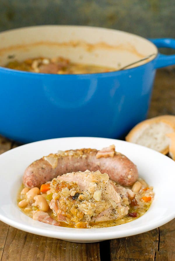 French Cassoulet stew wtih chicken and sausage in white bowl