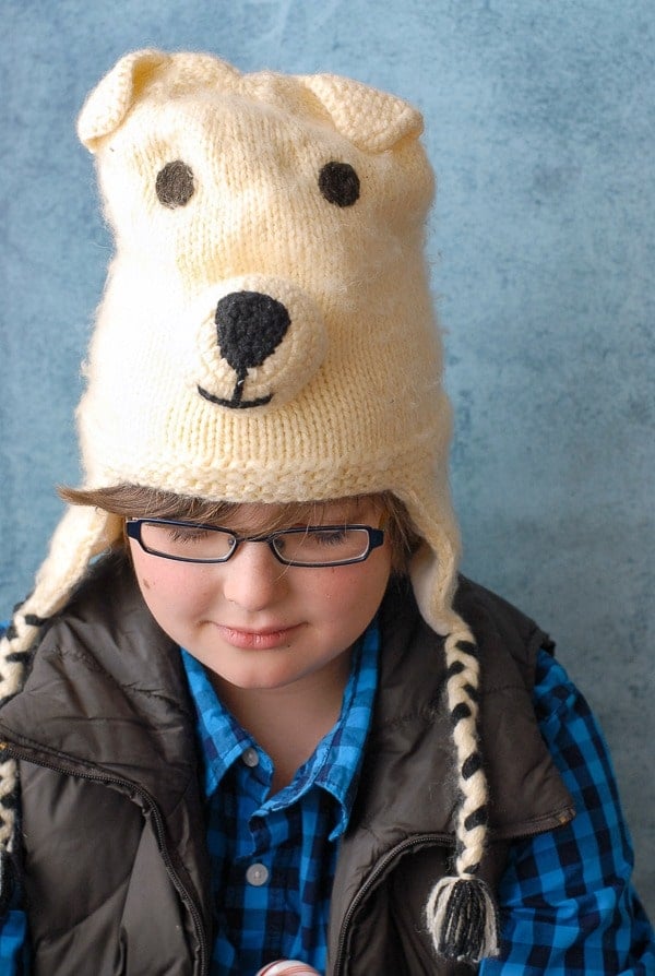 Cute boy in winter clothes and a handmade bear hat 