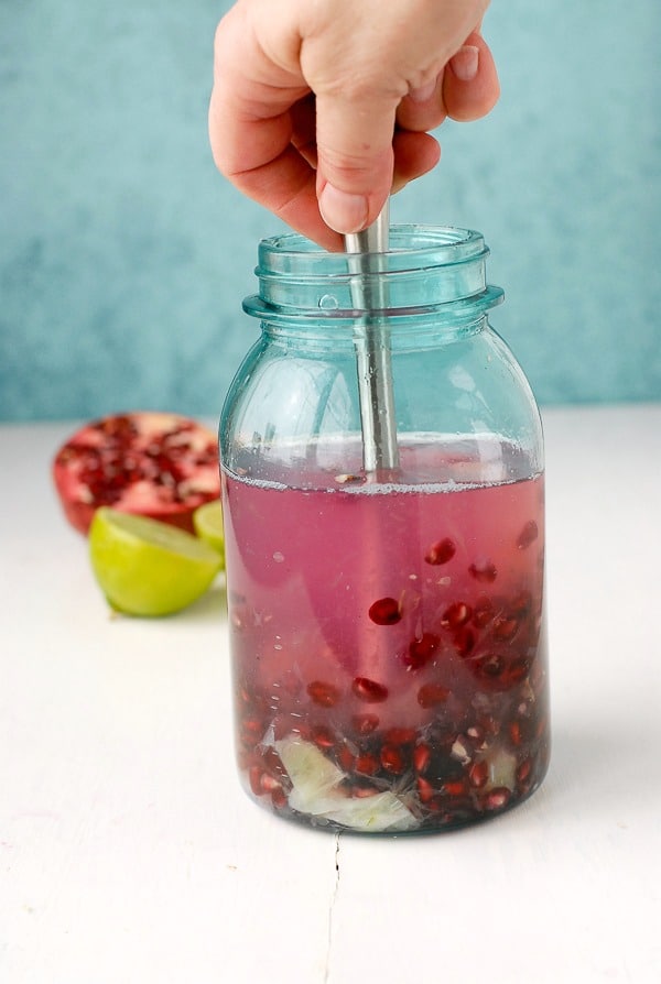 Pomegranate Lime Vodka infusion - muddling in jar