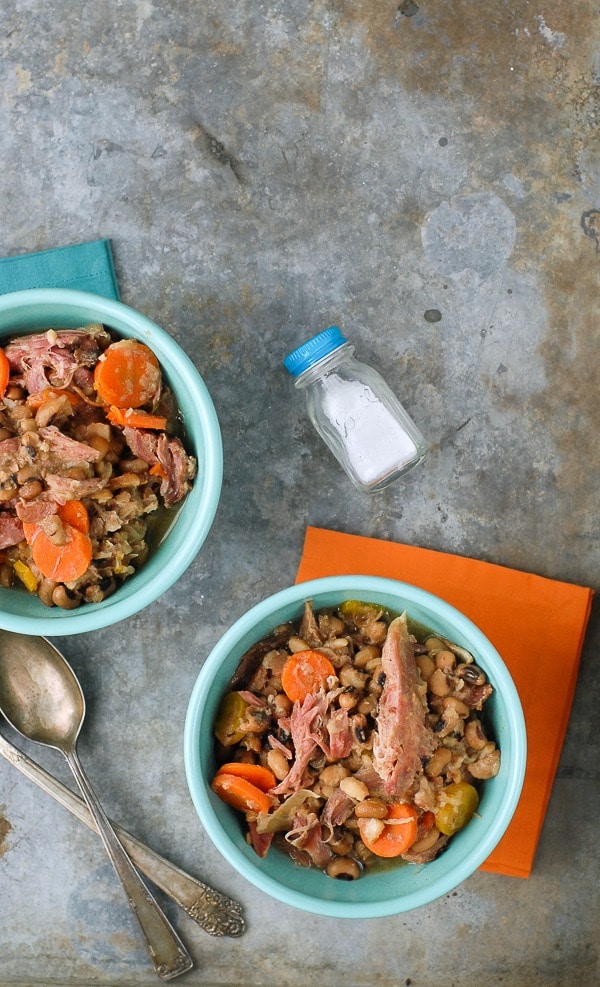 Slow Cooker Black Eyed Peas with Ham and Bacon in blue bowls