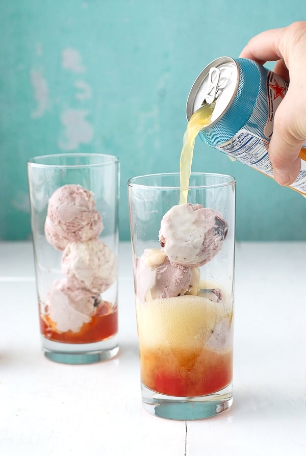 pouring orange soda into glasses to make Orange Soda Bourbon Cherry-Vanilla Ice Cream Floats