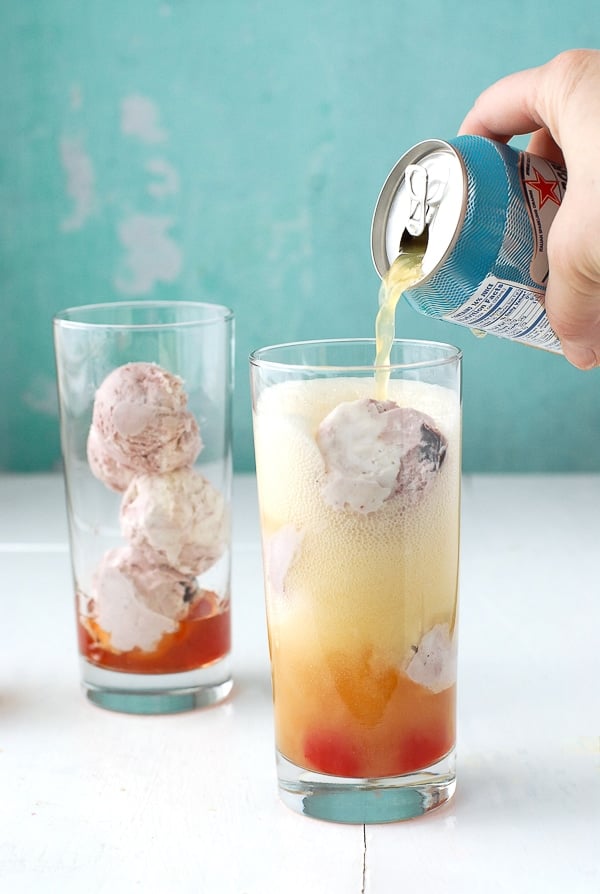 making Orange Soda Bourbon Cherry-Vanilla Ice Cream Floats, pouring in the orange soda