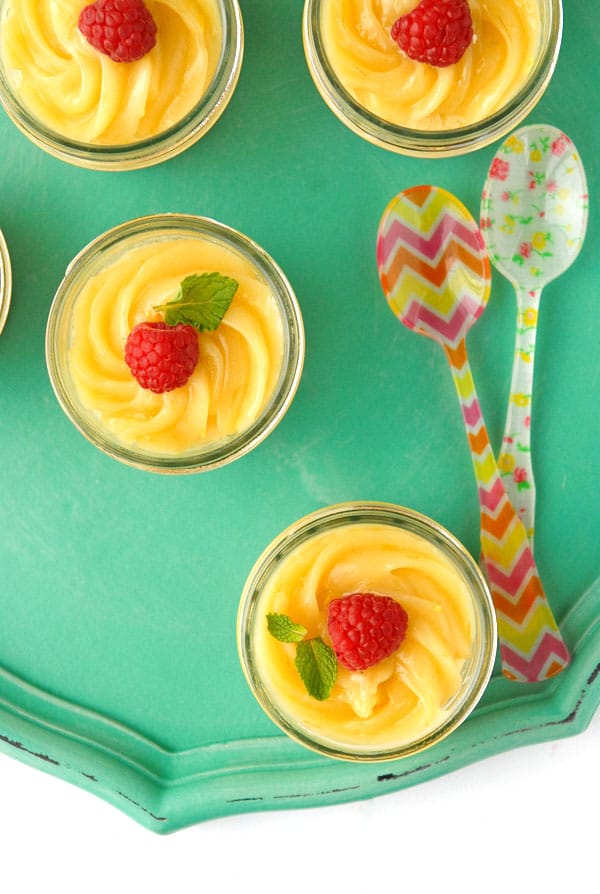 Mini Mascarpone Key Lime Curd Cheesecakes in mini jelly Jars with raspberries from above