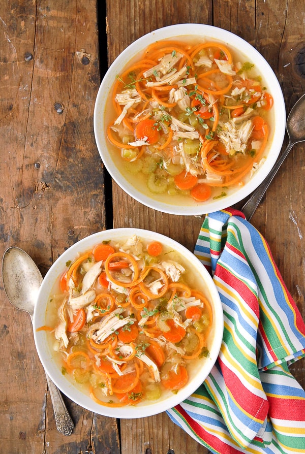 Two piping hot servings of Skinny Chicken Sweet Potato Noodle Soup with spiralized sweet potato noodles