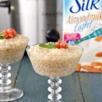 Slow Cooker Light Almond Milk Tapioca Pudding in glass goblets with slow cooker in background