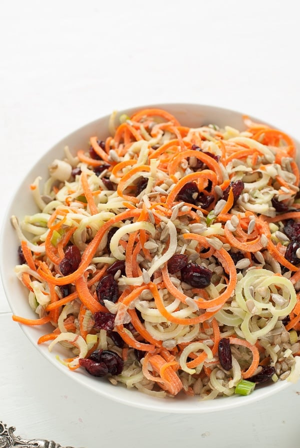 overhead view of a bowl of Spiralized Broccoli Stem Carrot Slaw with Dried Cranberries and Sunflower Seeds