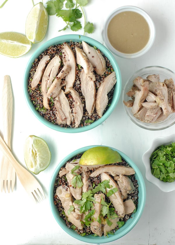 Thai Chicken Thigh Basil-Quinoa Bowl with lime wedges and fresh cilantro