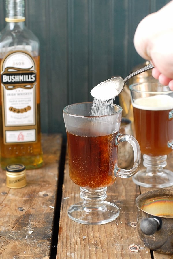 Authentic Irish Coffee recipe - pouring the sugar into the glass mug