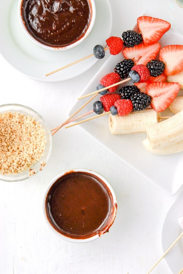 Chocolate Fondue pots with fruit skewers and nuts 