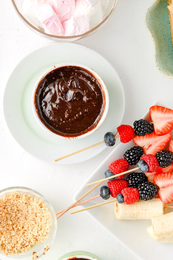 Chocolate Fondue pots with fruit skewers and nuts 