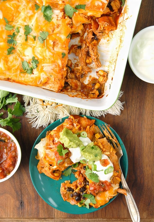 serving and pan of Chipotle Green Chile Chicken and Black Bean Enchiladas 