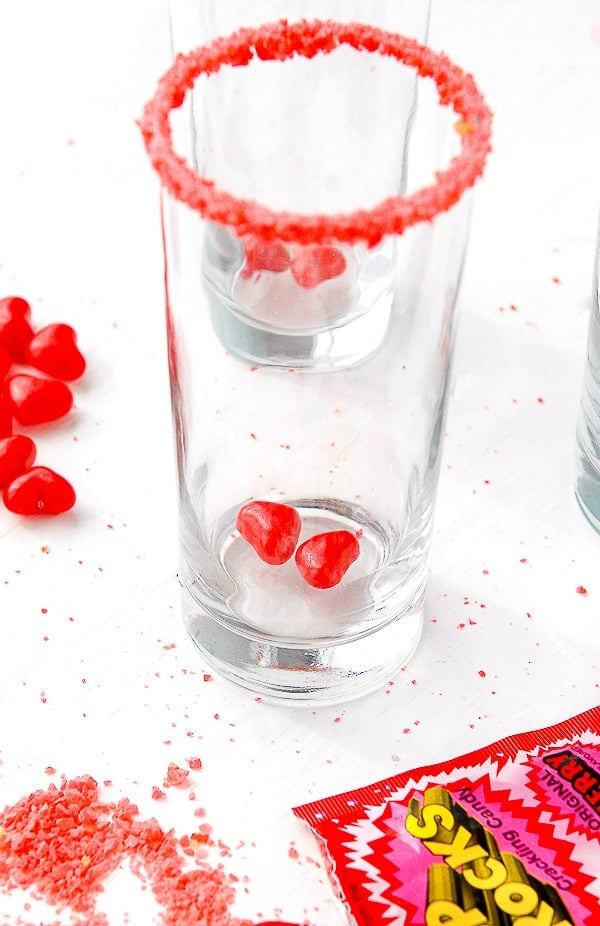Pop Rocks rimmed Love Potion Number 9 glass with Red Hots hearts at bottom