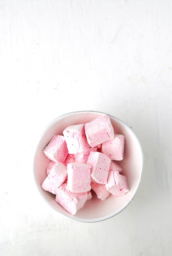Rose-flavored Marshmallows cut in squares in a white bowl.