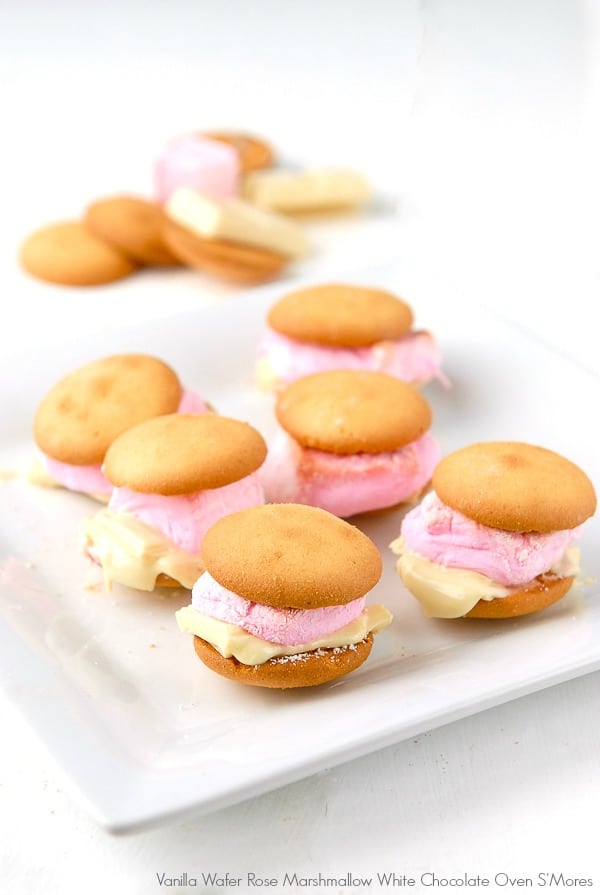 Oven S\'mores made with Vanilla Wafers, Rose Marshmallows, and melted White Chocolate on a white plate. 