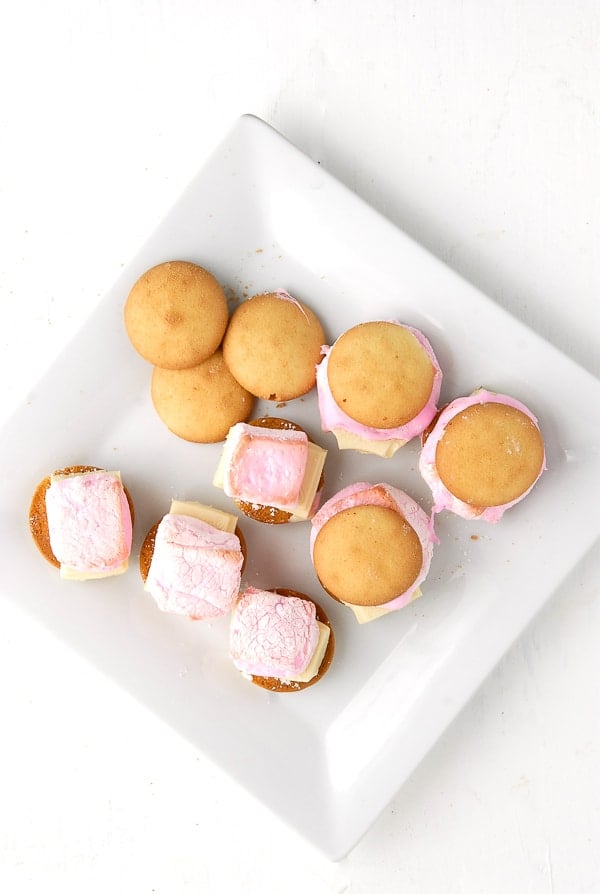 Vanilla Wafer Rose Marshmallow White Chocolate Oven S\'mores in preparation on a square white plate and background. 