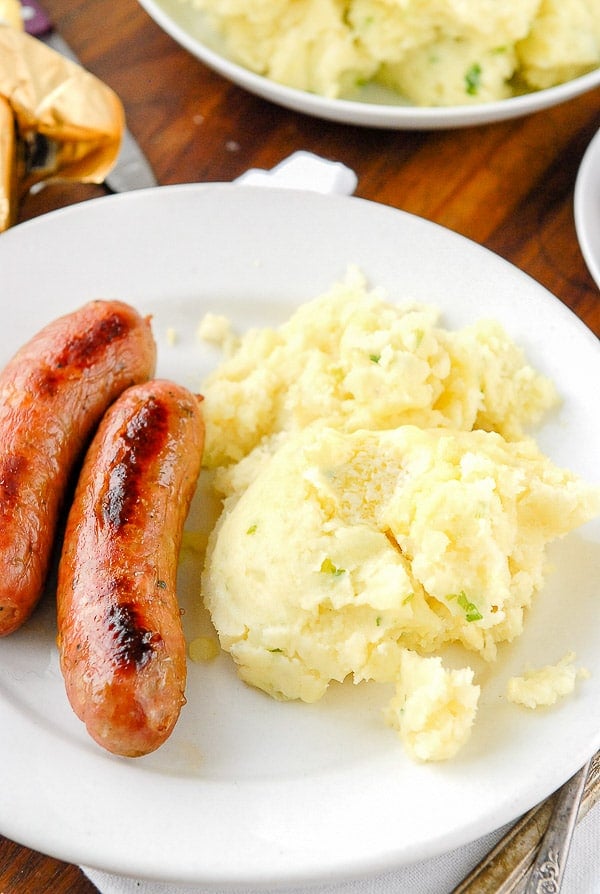 Plate of Irish Potato Champ and sausages close up