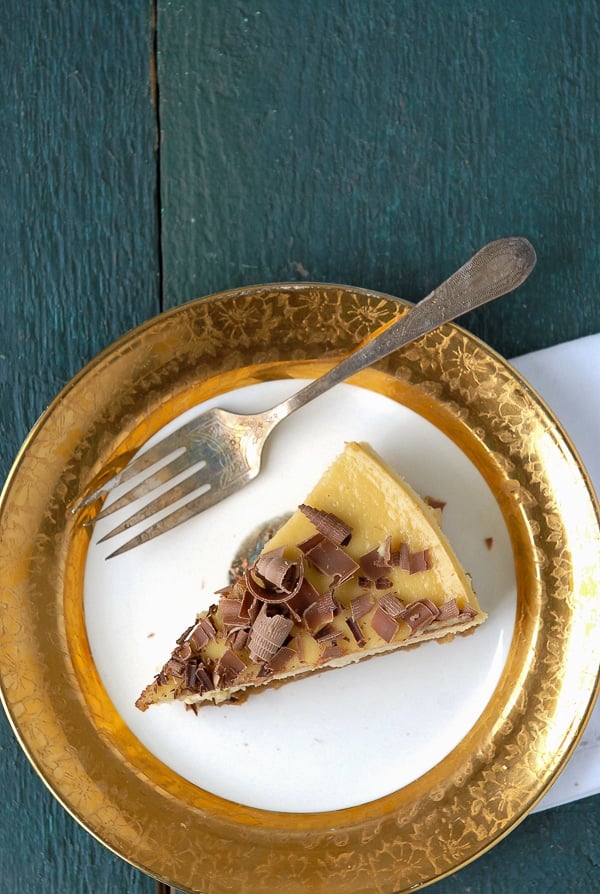 slice of Irish Whiskey and Baileys Cheesecake on gold rimmed plate