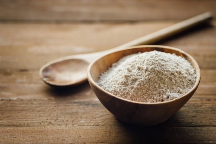 oat flour in wooden bowl